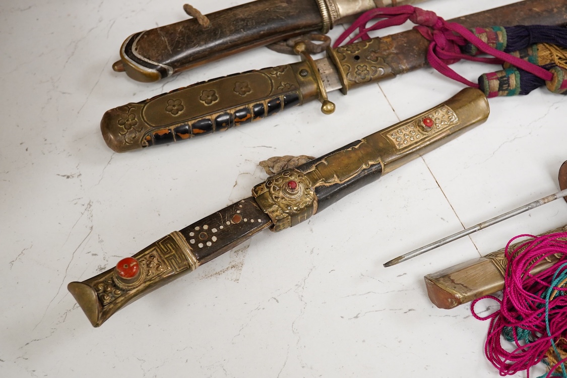 Four Tibetan daggers, early 20th century and a prayer wheel